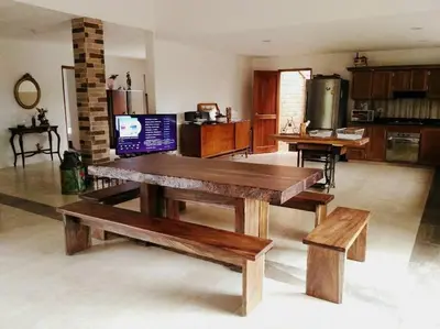 a living room with a wooden table and benches at Casa de Campo en Jardín Alojamiento Familiar in Jardin