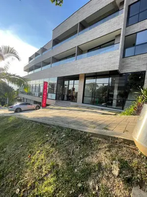 a building with a red sign in front of it at Apartamento con vista y aire acondicionado cerca a El Tesoro in Medellín