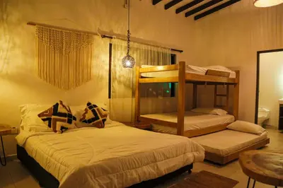 a bedroom with two bunk beds in a room at Finca Hotel Sawa in Maceo
