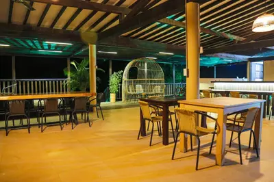 a group of tables and chairs in a restaurant at Finca Hotel Sawa in Maceo