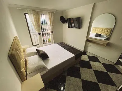 a bedroom with a large bed and a mirror at Vacacional, Casa ideal cerca a zona turística in Medellín