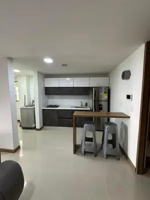 a kitchen with a wooden table and two stools at Sector Tranquilo y Central, Excelente Vista in Manizales