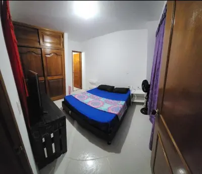 a bedroom with a bed and a tv in it at Restaurante Saman in Santa Fe de Antioquia