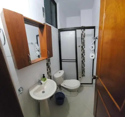 a small bathroom with a toilet and a sink at Restaurante Saman in Santa Fe de Antioquia