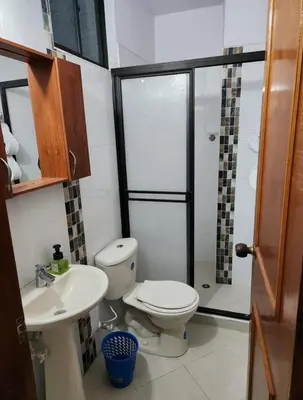 a bathroom with a toilet and a sink and a shower at Restaurante Saman in Santa Fe de Antioquia