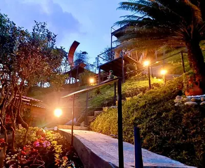 a person standing on a staircase at night with lights at La Finca De Frida in Guatapé
