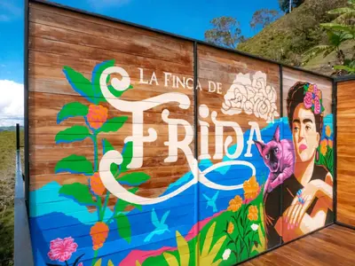 a mural on the side of a building with flowers at La Finca De Frida in Guatapé
