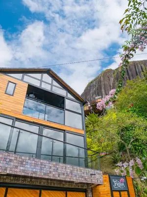 a building with a view of a mountain at La Finca De Frida in Guatapé