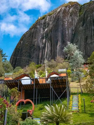 a group of tents in front of a mountain at La Finca De Frida in Guatapé