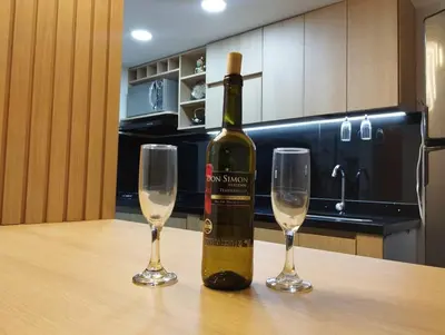 a bottle of wine sitting on a table with two glasses at Apartamento Piscina sabaneta Medellín 20 minutos Poblado in Envigado