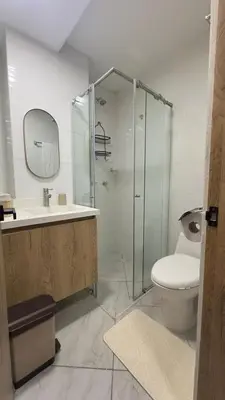 a bathroom with a toilet and a glass shower at Diamante 204 in Guatapé