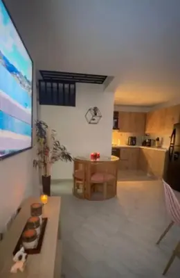 a living room with a table and a kitchen at Diamante 204 in Guatapé