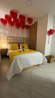 a bedroom with red hearts hanging from the ceiling at Diamante 204 in Guatapé