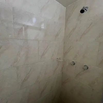 a bathroom with a large shower with a large tile shower at Hotel Villa Nueva Comfort in Medellín