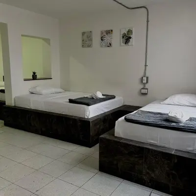 two beds sitting next to each other in a room at Hotel Villa Nueva Comfort in Medellín