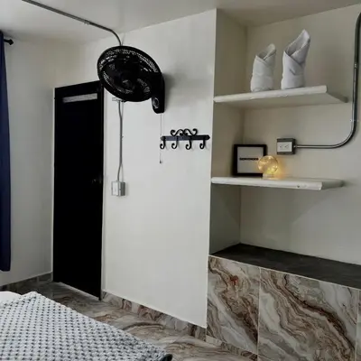 a bathroom with a shower with a black door at Hotel Villa Nueva Comfort in Medellín