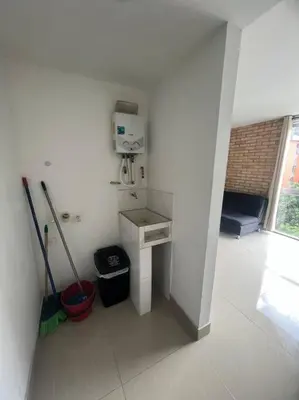 a white bathroom with a sink and a mop at Lindo apartamento poblado 111 in Medellín