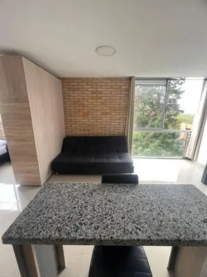 a living room with a table and a couch at Lindo apartamento poblado 111 in Medellín