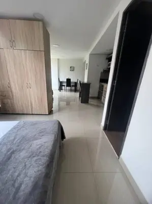 a bedroom with a bed and a dining room at Lindo apartamento poblado 111 in Medellín