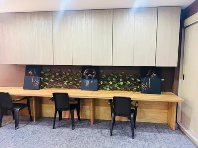 a wooden table with four chairs and a table with leaves at Lindo apartamento poblado 111 in Medellín
