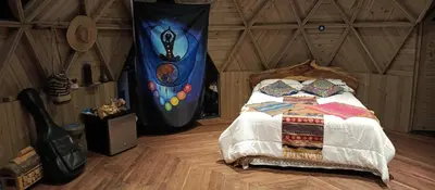 a bedroom with a bed in a room at Sanayá Domo Glamping - Santa Elena in Santa Elena