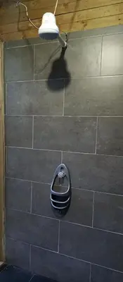 a room with a tile wall with a light on it at Sanayá Domo Glamping - Santa Elena in Santa Elena