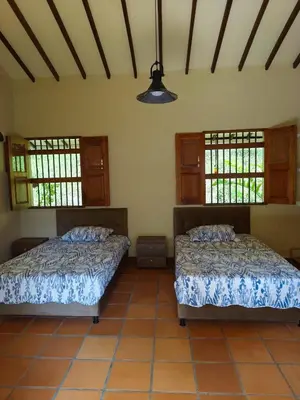 two beds sitting in a room with windows at Finca MonteSer in Jardin