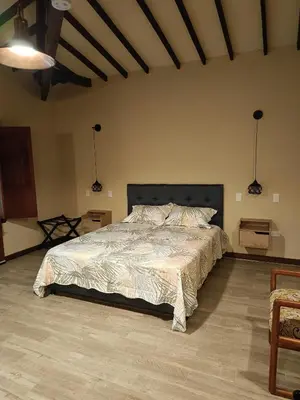 a bedroom with a large bed in a room at Finca MonteSer in Jardin