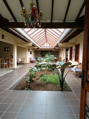 a conservatory with a patio with a garden and a ceiling at Finca MonteSer in Jardin