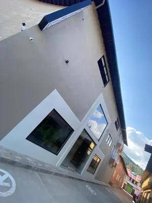a building with two large windows on the side of it at Hotel La Vega in Concepción