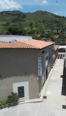 a building with a clock on the side of it at Hotel La Vega in Concepción