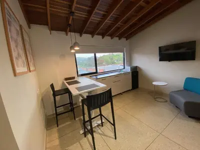 a living room with a table and chairs and a couch at Hotel La Vega in Concepción