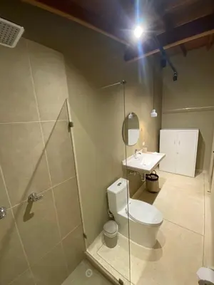 a bathroom with a toilet and a sink at Hotel La Vega in Concepción