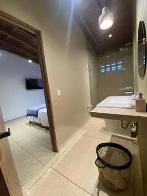 a bathroom with a sink and a mirror at Hotel La Vega in Concepción