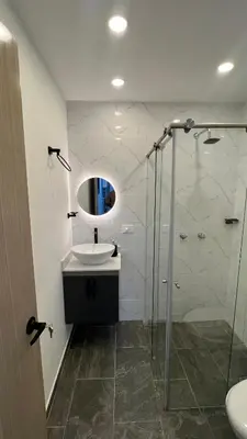 a bathroom with a sink and a glass shower at Apartamento céntrico en Medellín in Medellín
