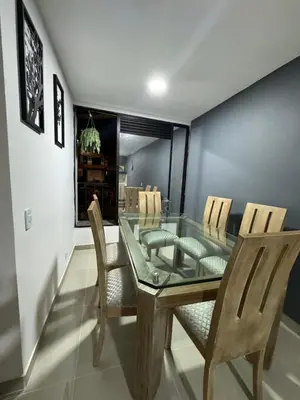 a dining room with a glass table and chairs at Apartamento céntrico en Medellín in Medellín