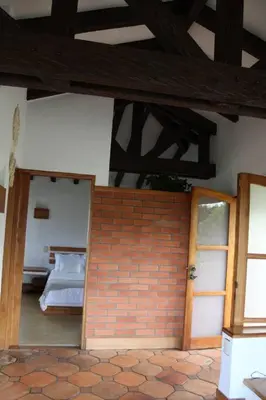 a bedroom with a bed and a brick wall at Casa finca pietrasanta in Rionegro