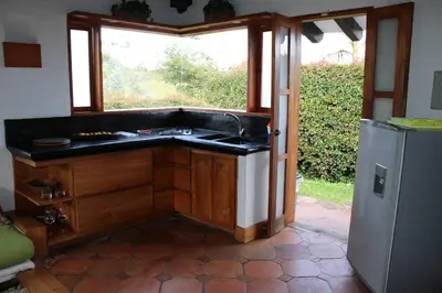 a kitchen with a sink and a window and a refrigerator at Casa finca pietrasanta in Rionegro