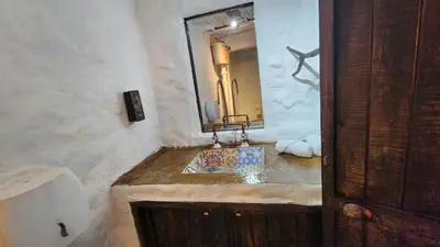 a bathroom with a sink and a mirror at Hobbit Hotel El peñol Guatapé in La Pradera