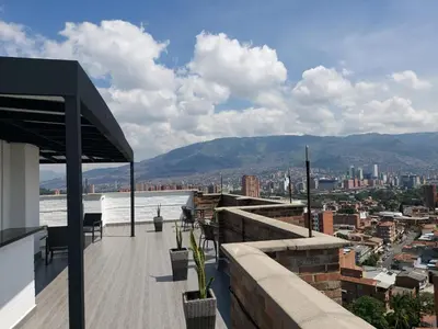 a balcony with a view of a city at Laureles Penthouse rooftop Suite in Medellín