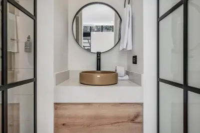 a bathroom with a round sink and a mirror at MULATA - Provenza 3 Story Villa with Pool & Rooftop in Medellín