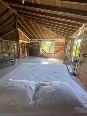 a large bed in the middle of a room at Finca Kikua in San Rafael