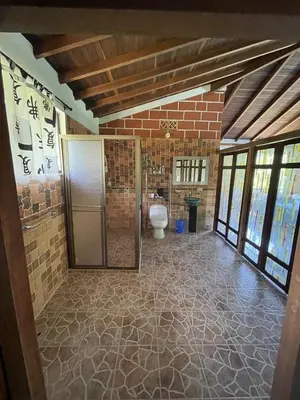 a bathroom with a toilet in a brick wall at Finca Kikua in San Rafael