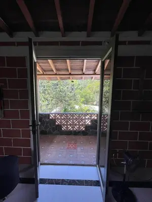 an open door to a patio with a brick wall at Finca Kikua in San Rafael
