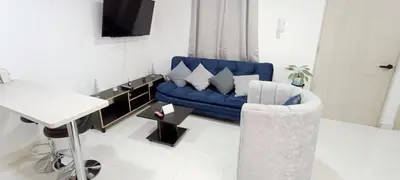 a living room with a blue couch and a table at Hermoso Apartamento en Belén in Medellín