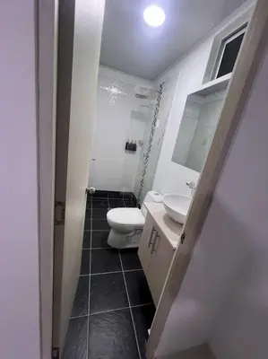 a small bathroom with a toilet and a sink at Hermoso Apartamento en Belén in Medellín