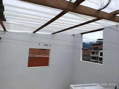 a white wall with two windows in a building at Apartamento en Guatapé por noches in Guatapé