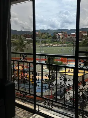 a view of a field from a balcony at Apartamento en Guatapé por noches in Guatapé