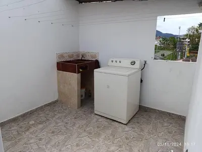 a white washing machine in a room with a window at Apartamento en Guatapé por noches in Guatapé