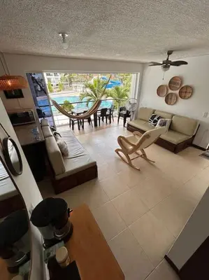 a living room with a view of a living room with a table at Casa Lupita Hermoso apartasol in Santa Fe de Antioquia